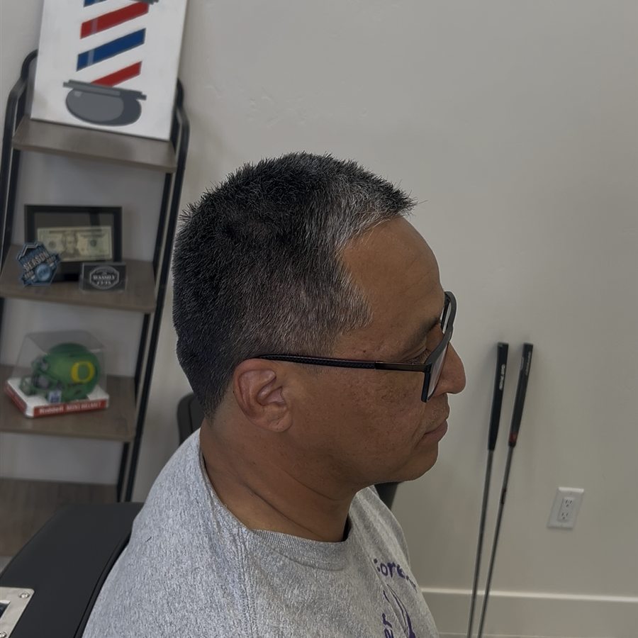 Short haircut with clean taper, right profile