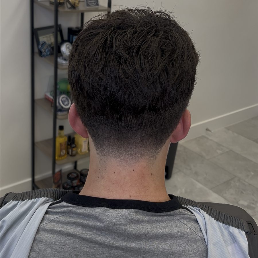 Client haircut with clean tapered neckline, back view