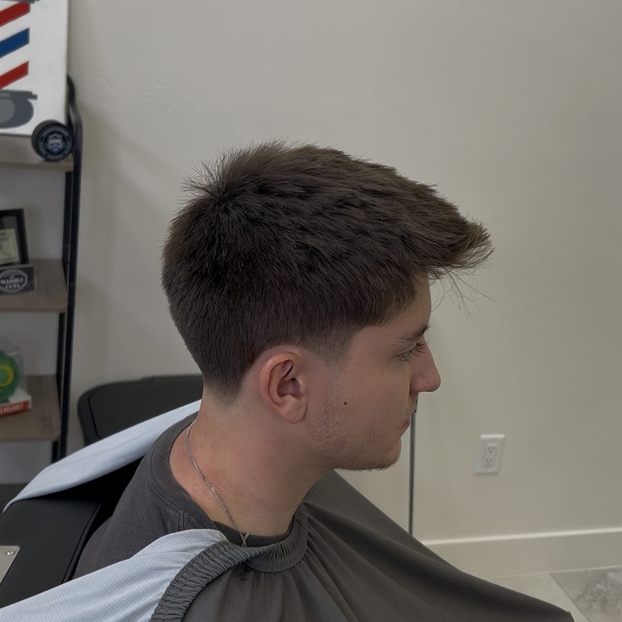 Client haircut with short top and tapered side, right profile