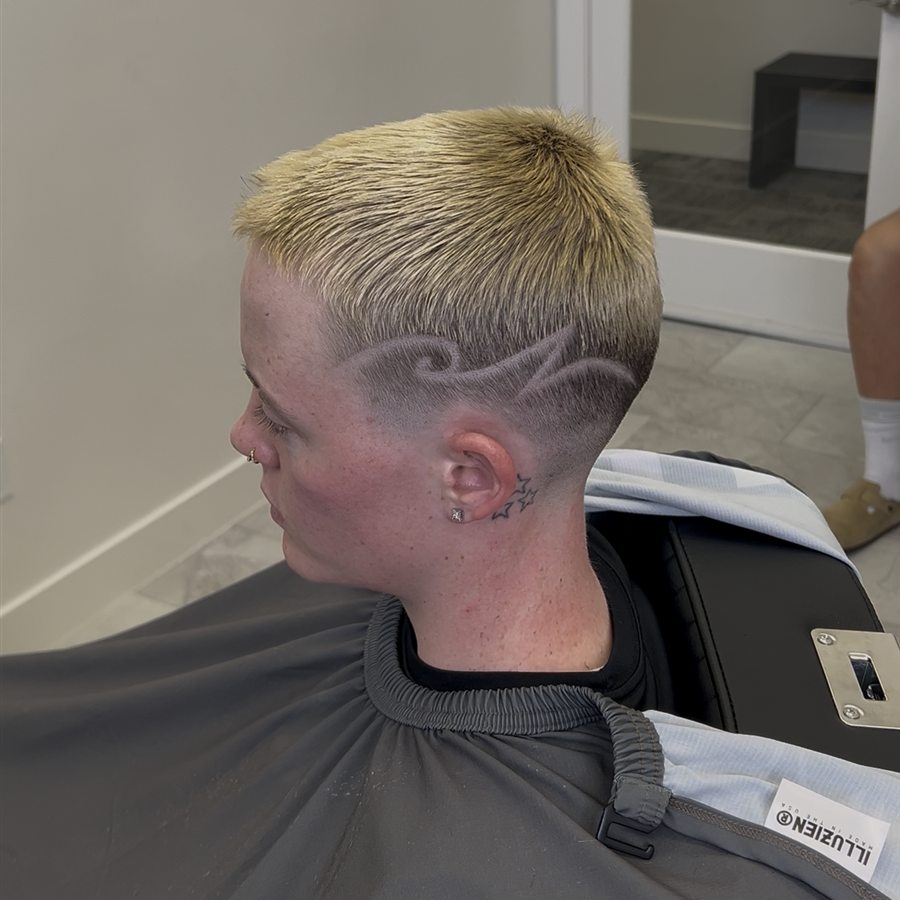 Blond haircut with shaved design detail